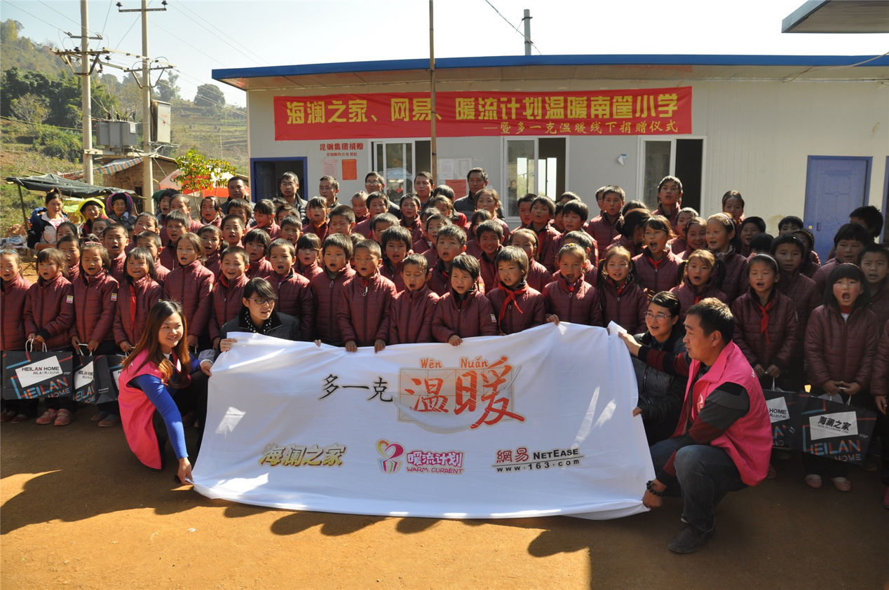 2014年11月20日，&ldquo;多一克溫暖&rdquo;公益團隊來到8.3大地震的重災區(qū)&mdash;&mdash;云南省昭通市魯?shù)榭h的南筐小學。越過崎嶇山路，將一批又一批暖心羽絨服送到了師生們的手中，也將社會的關懷和愛意傳遞給了這些可愛的人。