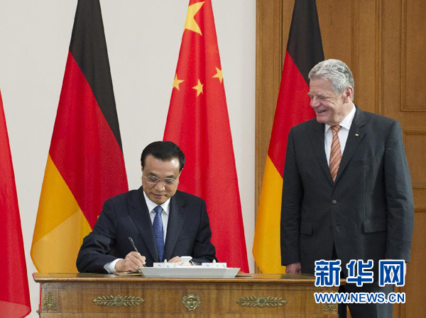 10月10日，國務(wù)院總理李克強(qiáng)在柏林會(huì)見德國總統(tǒng)高克。這是李克強(qiáng)總理在高克總統(tǒng)的陪同下在貴賓簿上簽字。 新華社記者 王曄 攝 